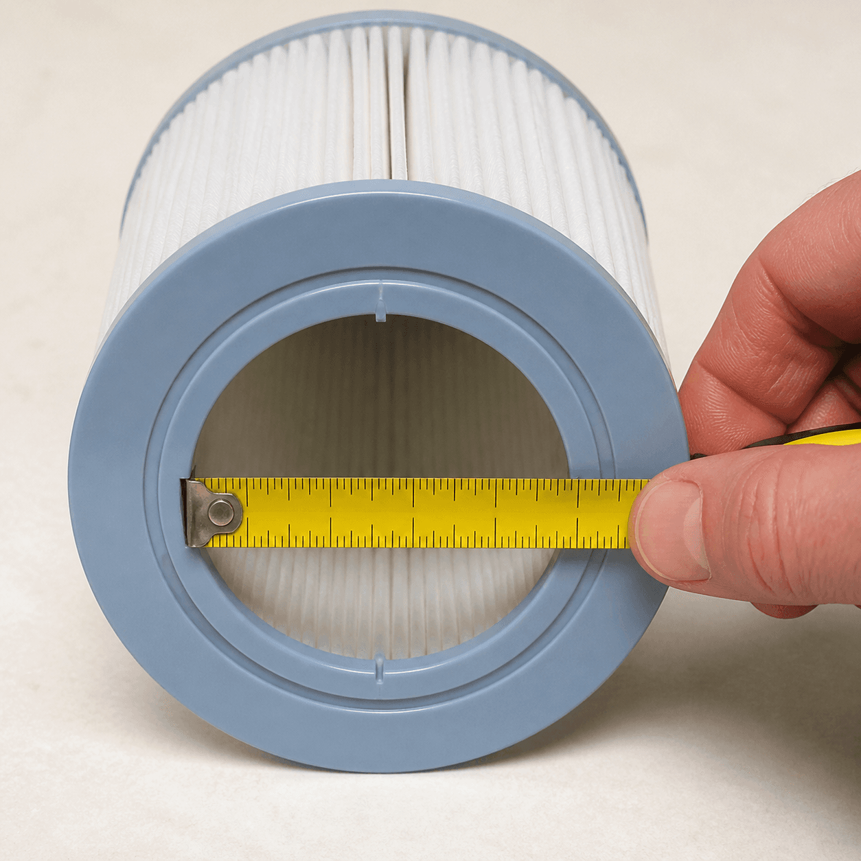 Tape measure spanning the open bottom hole of a short spa filter cartridge
